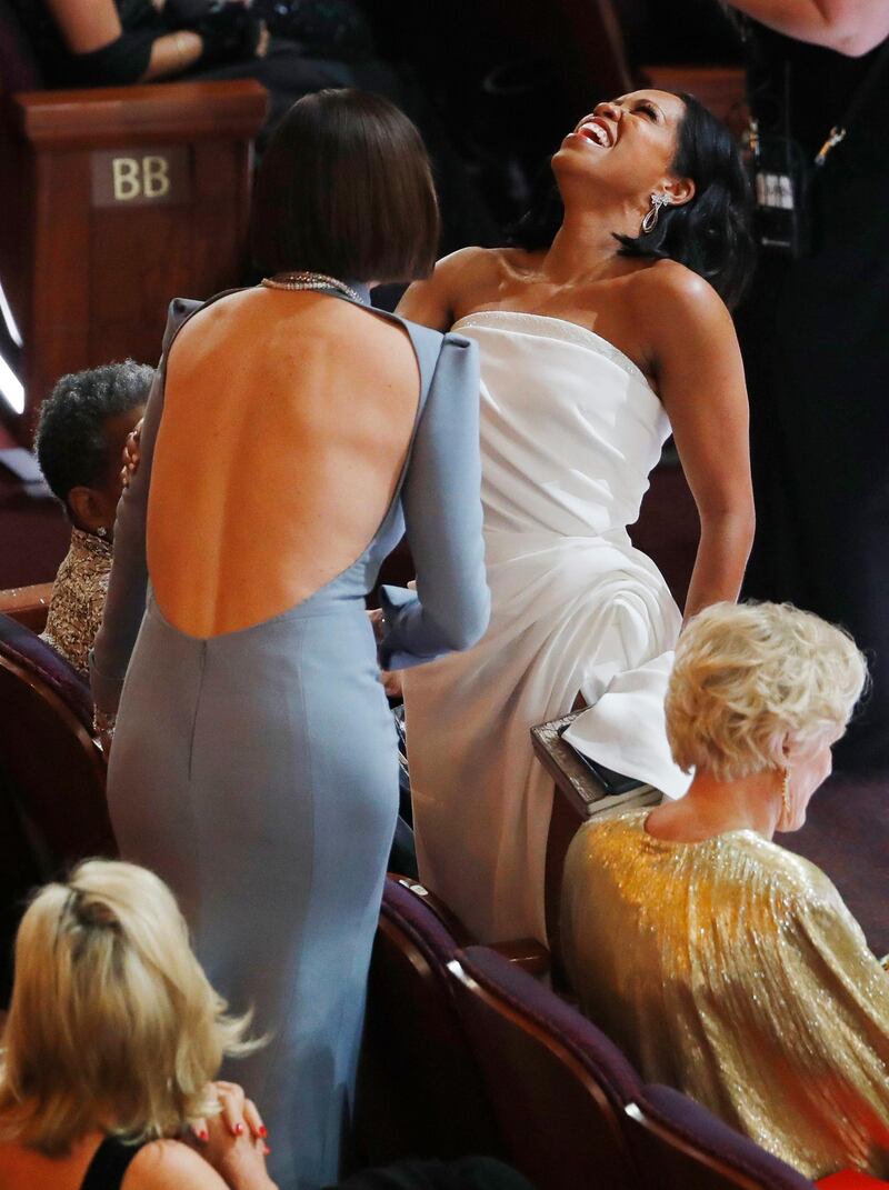 Regina King and Charlize Theron (L) share a joke ahead of the show as Glenn Close relaxes. Photo: Reuters