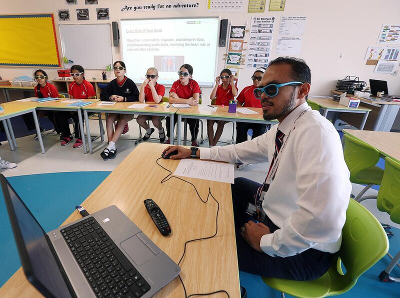 Ridwan Falah, teacher of Maths with pupil of Grade 5 demonstrates with 3-D effect at Aldar’s West Yas Academy in Abu Dhabi. Satish Kumar / The National