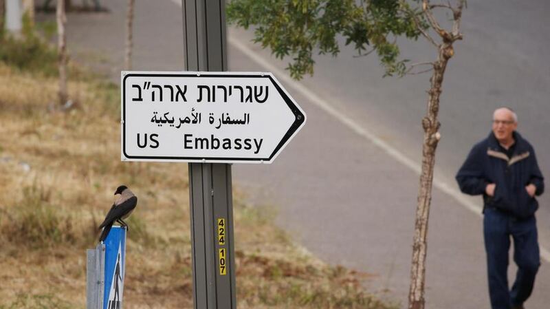 A man walks next to a road sign directing to the US embassy, in the area of the US consulate in Jerusalem, May 7, 2018. Reuters