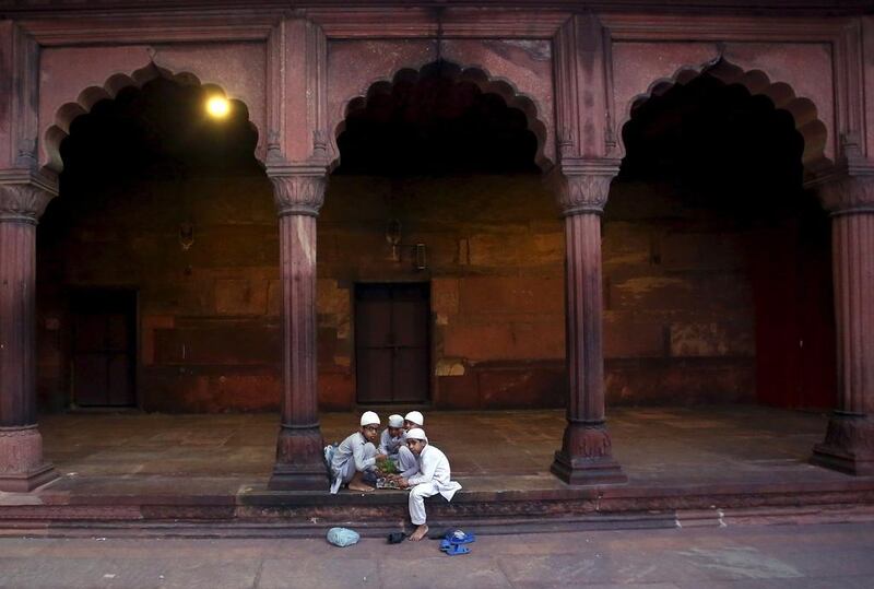 Muslim children eat their iftar (breaking of fast) meal during the holy month of Ramadan at the Jama Masjid (Grand Mosque) in the old quarters of Delhi, India, on June 20, 2015. Anindito Mukherjee / Reuters