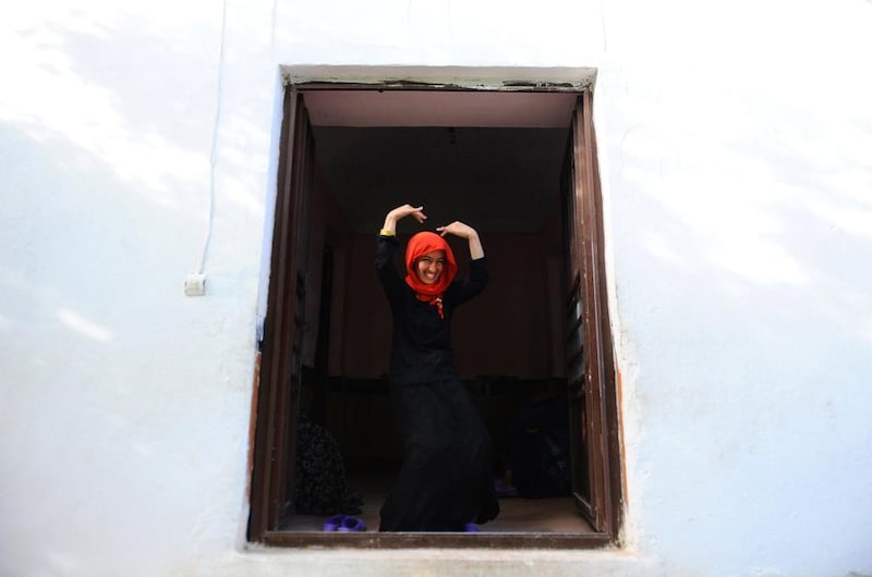 An Afghan patient dances in front of her room in the female ward.