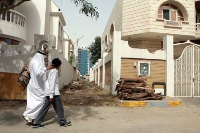 March 30, 2011 / Abu Dhabi / (Rich-Joseph Facun / The National) Trees near a villa recently cut down by the municipality lay stacked in a pile, Wednesday, March 30, 2011 in Abu Dhabi.  
Location is between 13th and 15th streets in Abu Dhabi near the Eid prayer yard
