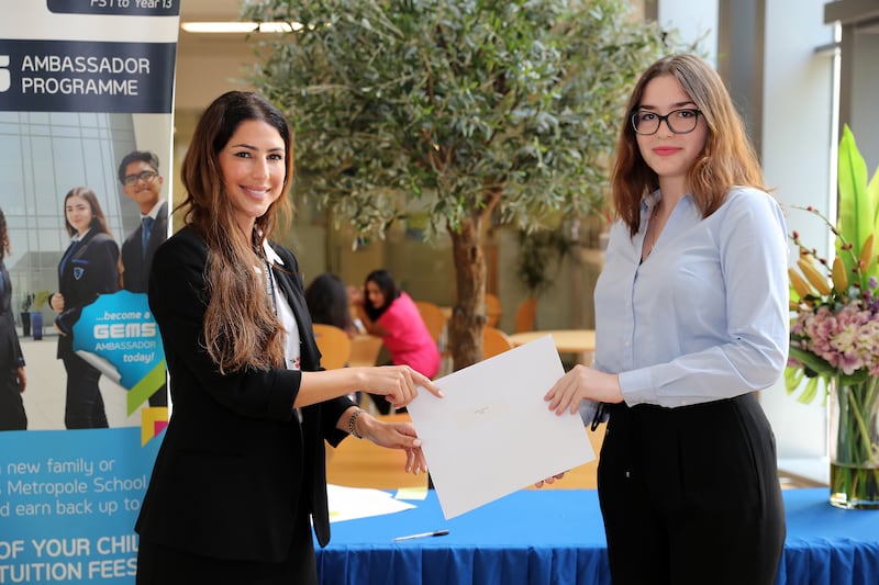 Daniella Aschettino, Head of Secondary at Gems Metropole School presenting A-level results to student Kateryna.