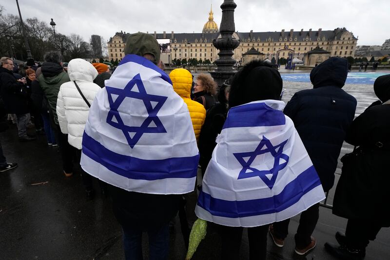 Members of the Jewish community gather outside the Invalides monument. AP