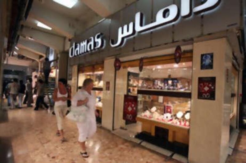 DUBAI, UNITED ARAB EMIRATES - APRIL 19:  Women walk past a Damas jewellery store in the Gold Souk area of Dubai on April 19, 2010.  (Randi Sokoloff / The National)  For Business Stock