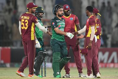 Pakistan's Mohammad Nawaz (2ndL) and teammate Khushdil Shah (C) shake hands with West Indies' players after their victory during the first one-day international (ODI) cricket match between Pakistan and West Indies at the Multan Cricket Stadium in Multan on June 8, 2022.  (Photo by Aamir QURESHI  /  AFP)