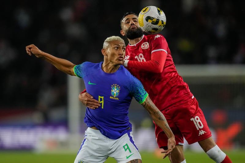 Tunisia's Ghaylen Chaaleli, right, duels for the ball with Brazil's Richarlison. AP Photo 