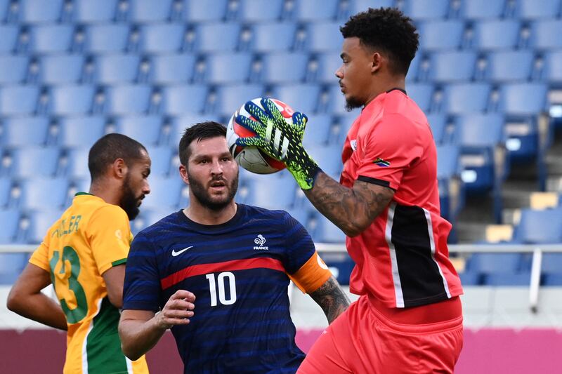 South Africa's goalkeeper Ronwen Williams collects the ball ahead of France's forward Andre-Pierre Gignac.