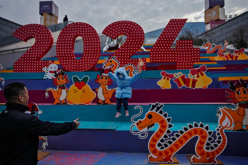 A child at a shopping mall displaying dragons in Beijing. 2024, is the Year of the Dragon on the Chinese calendar. AP