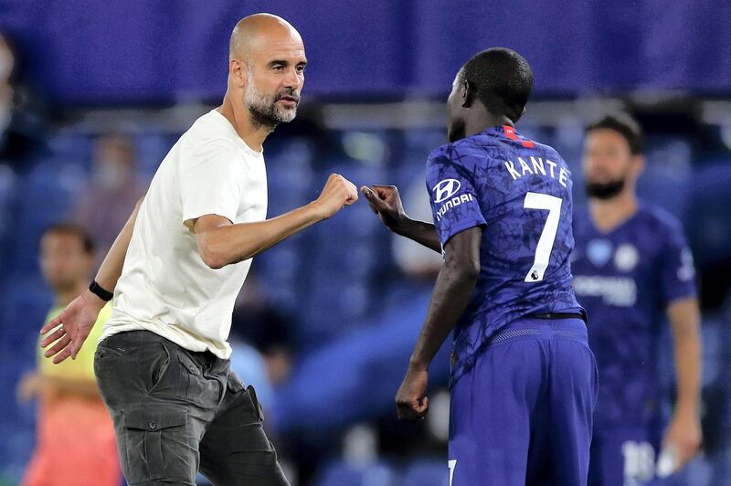 Manchester City's Spanish manager Pep Guardiola elbow bumps with Chelsea's French midfielder N'Golo Kante after the English Premier League football match between Chelsea and Manchester City at Stamford Bridge in London on June 25, 2020. - Cheslea won the match 2-1. Jurgen Klopp's legendary status at Anfield was secured on Thursday as he became the first Liverpool manager to win a league title in 30 years. (Photo by PAUL CHILDS / POOL / AFP) / RESTRICTED TO EDITORIAL USE. No use with unauthorized audio, video, data, fixture lists, club/league logos or 'live' services. Online in-match use limited to 120 images. An additional 40 images may be used in extra time. No video emulation. Social media in-match use limited to 120 images. An additional 40 images may be used in extra time. No use in betting publications, games or single club/league/player publications. / 