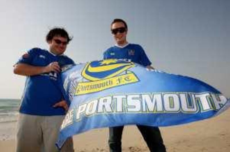 
DUBAI, UNITED ARAB EMIRATES Ð July 22: Left to Right- Nathan Hunt and Craig Johnston with portsmouth flag and wearing shirts at Jumeirah beach near Burj Al Arab hotel in Dubai.  (Pawan Singh / The National) For News. *** Local Caption ***  PS02- PORTSMOUTH.jpg