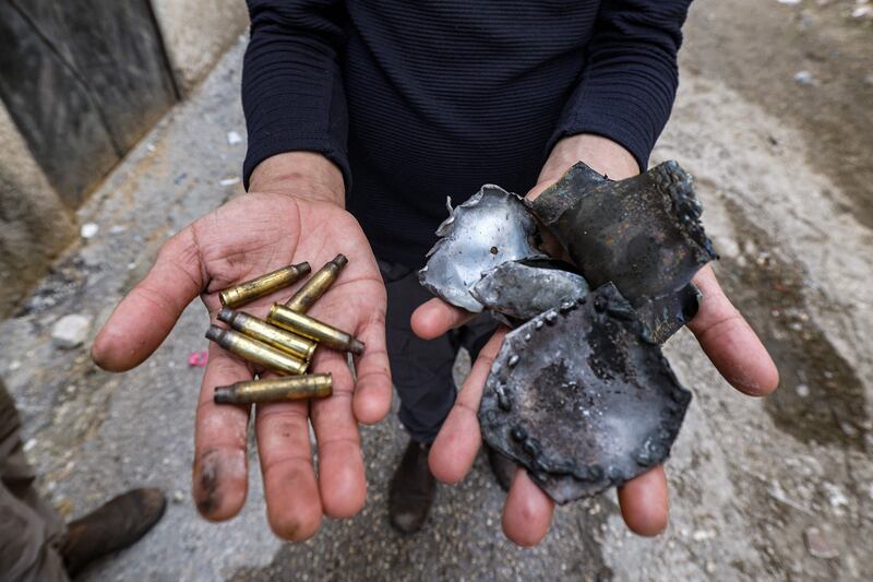 A man holds bullet casings and shrapnel found following an Israeli military operation at the Jenin camp for Palestinian refugees in the occupied West Bank on Tuesday. AFP
