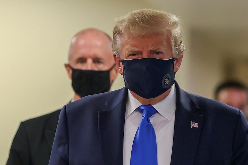 US President Donald Trump wears a mask while visiting Walter Reed National Military Medical Centre in Bethesda, Maryland, US. Reuters