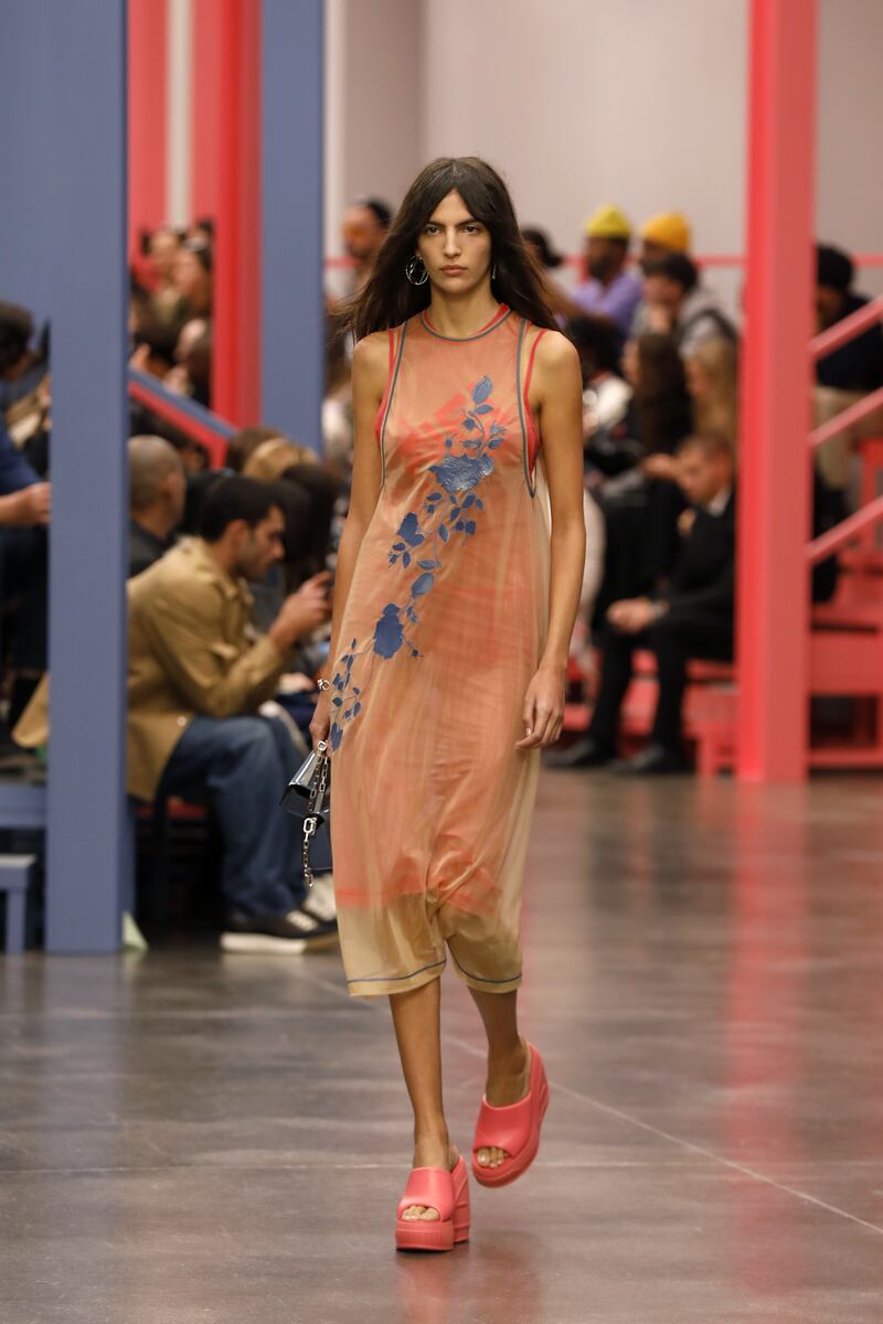 In shades of orange, an embroidered slip dress, worn over a strappy dress at Fendi. Getty 