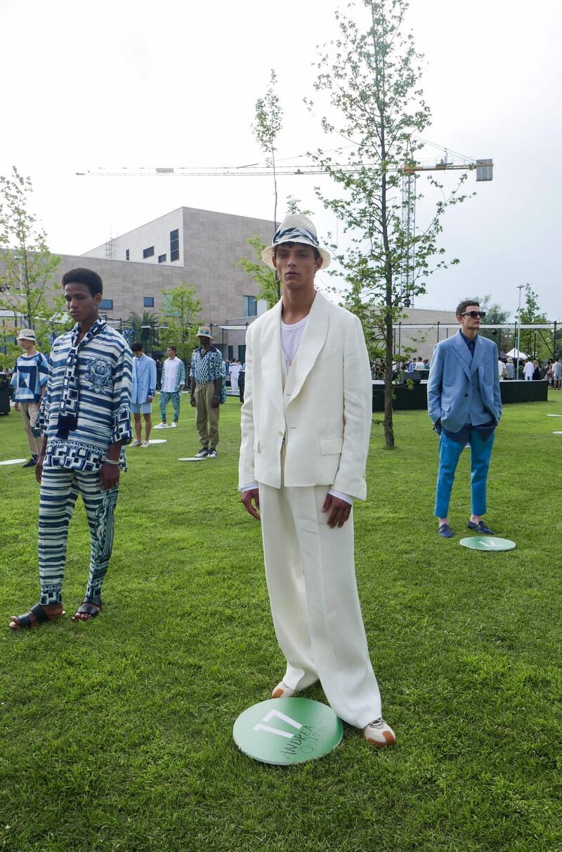 Models social distance from one another during the Dolce & Gabbana Spring / Summer 2021 men's collection in a live-streamed show during Milan Digital Fashion Week. AFP