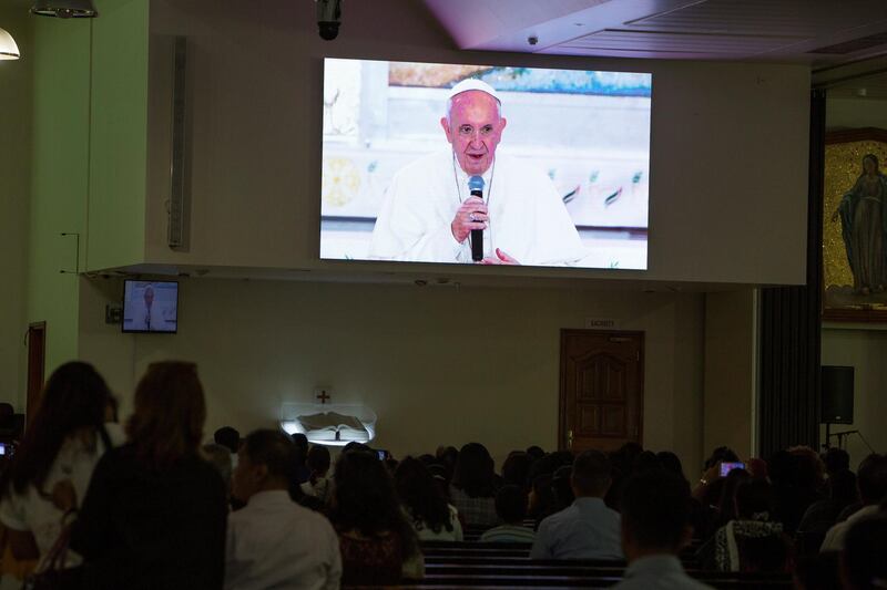  DUBAI, UNITED ARAB EMIRATES - Worshipper watch Pope Francis arrived at St. Francis Church in Abu Dhabi at St. Mary's Church, Oud Mehta.  Leslie Pableo for The National for Nick Webster's story