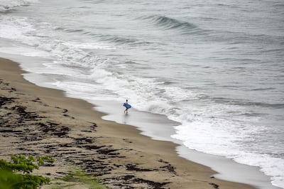 A person walks along a beach ahead of Tropical Storm Dorian in Patillas, Puerto Rico, on Wednesday, Aug. 28, 2019. Tropical Storm Dorian is about to lash Puerto Rico with torrential rains, and then is expected to gain strength and become the first major hurricane to hit Florida's east coast in 15 years. Photographer: Xavier Garcia/Bloomberg