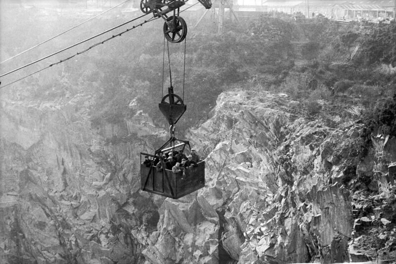 Workers at Rubislaw quarry in Aberdeen in 1955 using a Blondin to reach the work surface of the open quarry, which is about 150 metres deep. The container, named after the French tightrope walker Charles Blondin, can hold five tonnes at a time and is usually used to carry the granite. Getty Images