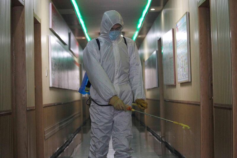 A man of the Hygienic and Anti-epidemic Center in Phyongchon District disinfects a corridor of a building in Pyongyang. AP Photo