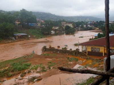 A torrent of water flows through a flooded neighbourhood in Regent, east of Freetown, Sierra Leone Monday, Aug. 14 , 2017. Mudslides and torrential flooding killed many people in and around Sierra Leone's capital early Monday following heavy rains, with many victims still thought to be trapped in homes buried under tons of mud. (AP Photo/ Manika Kamara)