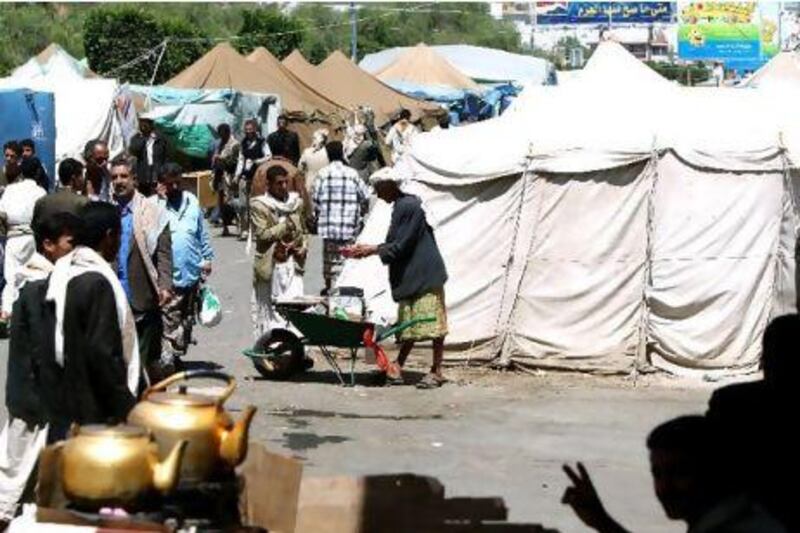Yemenis stroll past tents for anti-goverment protesters this month in what they call Freedom Square in the heart of Sanaa.