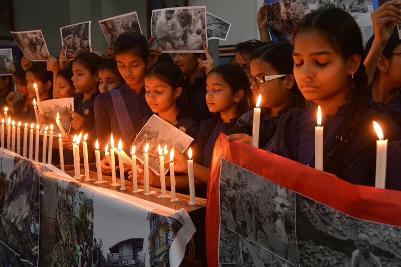 Indian schoolgirls offer prayers for the victims of the Nepal earthquake at a school in Amritsar on April 27, 2015. India is home to a sizeable number of Nepalese migrants and has close ties with its northern neighbour. Narinder Nanu / AFP
