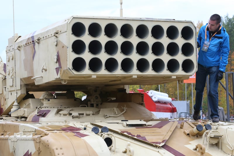 A participant stands on a Russian TOS-1 Buratino multiple rocket launcher during "Russia Arms Expo 2013".  Reuters