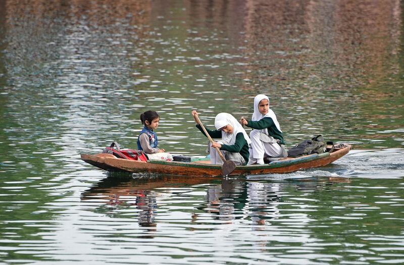 Kashmiri schoolgirls make their way to school on a shikara boat across the waters of Dal Lake, in Srinagar, India. AFP