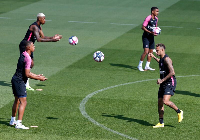 Mbappe and Neymar play the ball during a training session. AP Photo