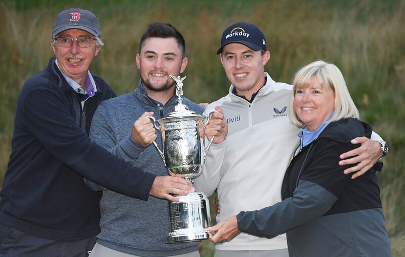 Matt Fitzpatrick of England along with father Russell, brother Alex and mother Susan, holds the trophy after winning the 2022 US Open. EPA