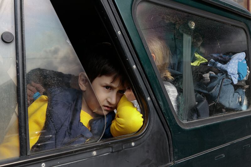 An ethnic Armenian boy from Nagorno-Karabakh, looks on from a car upon arrival in Goris. AP