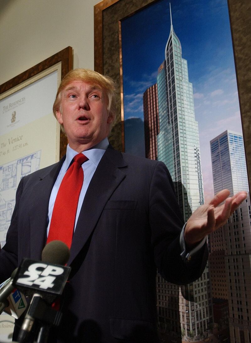 New York real estate developer Donald J. Trump officially opens the Presentation Centre for the Residences at The Ritz-Carlton Toronto, pictured at right,  29 November 2001. The USD 209 million  mixed condominium and hotel will stand 65 storeys, making it the tallest residential building in Canada and the first five-star hotel in Toronto once completed in 2004.  AFP PHOTO/J.P. Moczulski (Photo by J.P. MOCZULSKI / AFP)