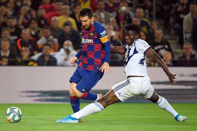 Barcelona's Argentine forward Lionel Messi vies with Valladolid's Ghanaian defender Mohammed Salisu during the Spanish league football match between Barcelona and Real Valladolid at the Camp Nou stadium in Barcelona. AFP / LLUIS GENE