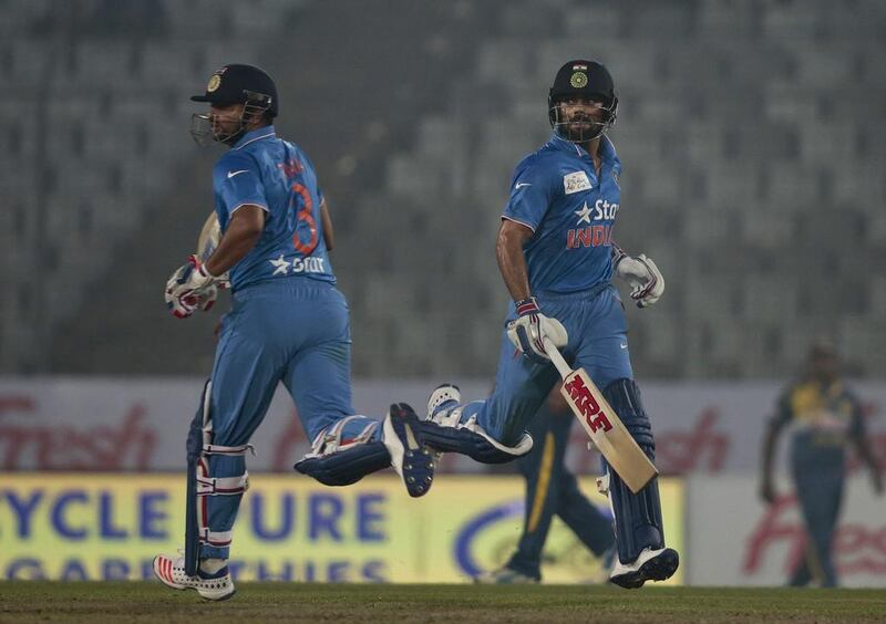 India’s Virat Kohli, right, and Suresh Raina run between the wickets during the Asia Cup Twenty20 international cricket match against Sri Lanka in Dhaka, Bangladesh, Tuesday, March 1, 2016. (AP Photo/A.M. Ahad)