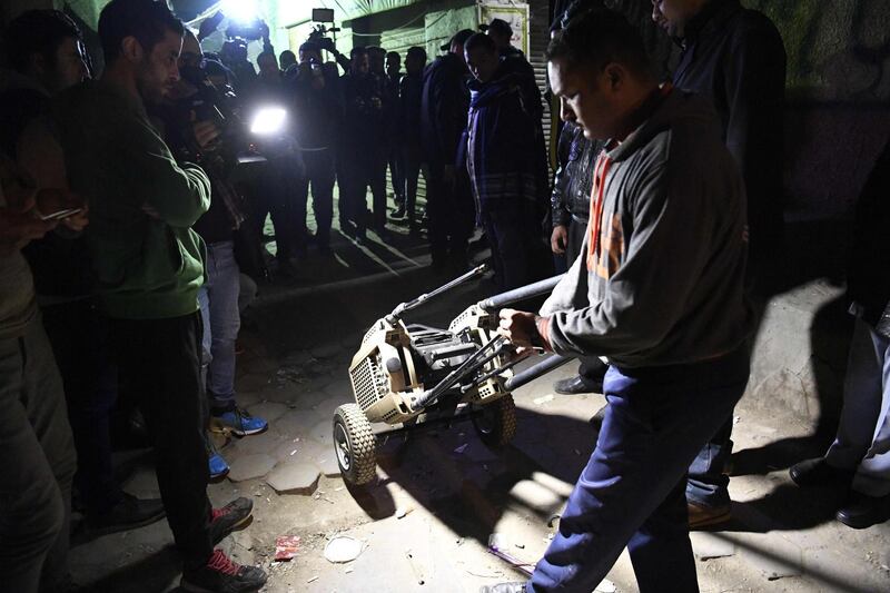 An Egyptian police officer in plainclothes rolls a piece of equipment to the site. AFP