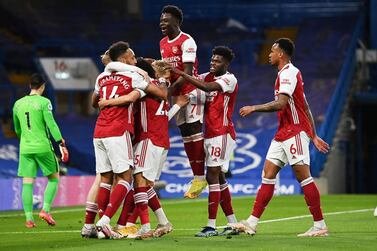 Arsenal's Emile Smith Rowe, left, celebrates with his teammates after scoring the winner at Chelsea. AP