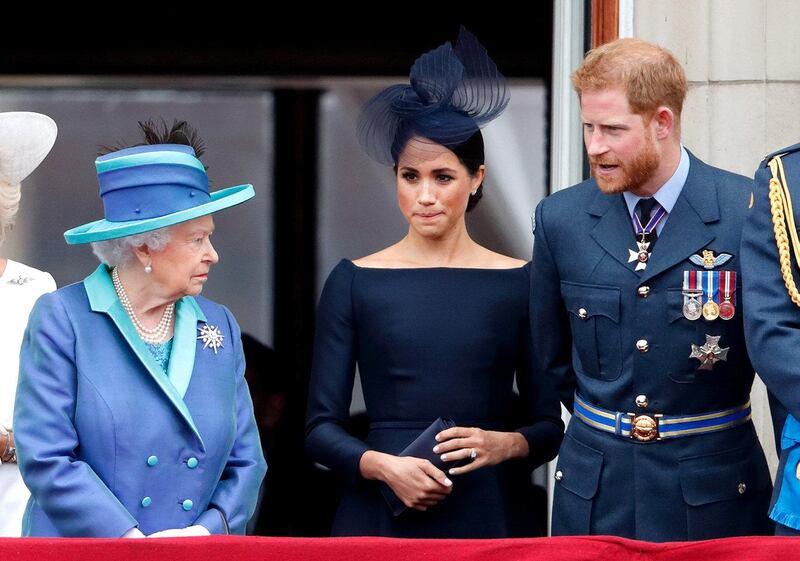 LONDON, UNITED KINGDOM - JULY 10: (EMBARGOED FOR PUBLICATION IN UK NEWSPAPERS UNTIL 24 HOURS AFTER CREATE DATE AND TIME) Queen Elizabeth II, Meghan, Duchess of Sussex and Prince Harry, Duke of Sussex watch a flypast to mark the centenary of the Royal Air Force from the balcony of Buckingham Palace on July 10, 2018 in London, England. The 100th birthday of the RAF, which was founded on on 1 April 1918, was marked with a centenary parade with the presentation of a new Queen's Colour and flypast of 100 aircraft over Buckingham Palace. (Photo by Max Mumby/Indigo/Getty Images)