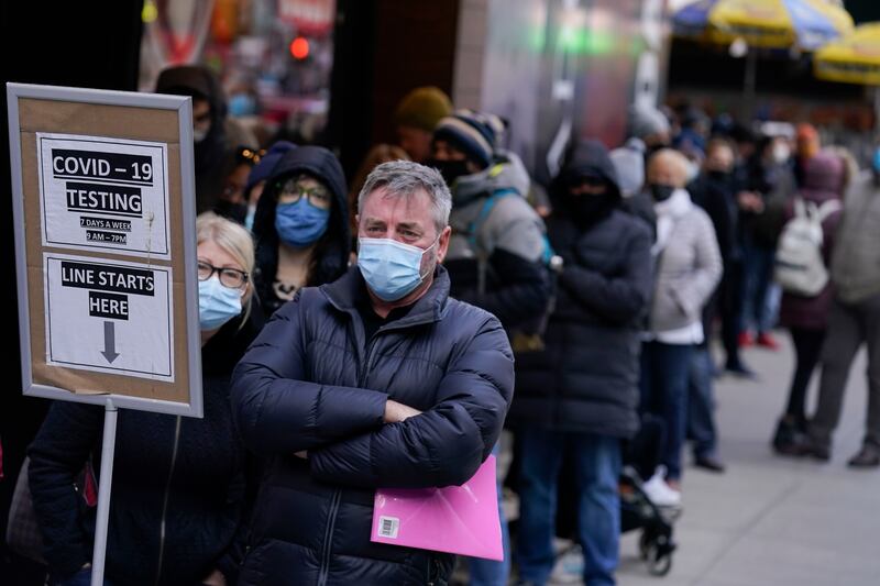 People wait in line at a Covid-19 testing site in Times Square, New York. AP