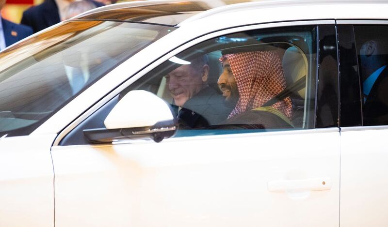 Saudi Crown Prince Mohammed bin Salman test-drives a Turkish-made electric car, one of two given to him by Mr Erdogan, in Jeddah. SPA
