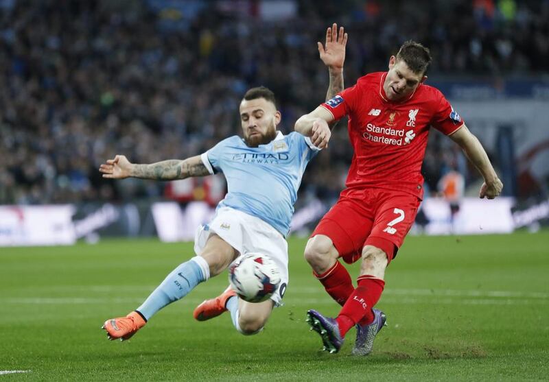 Liverpool’s James Milner has a shot at goal as Manchester City’s Nicolas Otamendi looks on. Reuters / Eddie Keogh