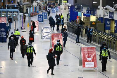 Police officers patrol on the concourse at London Waterloo railway station in London, U.K., on Tuesday, Jan. 5, 2021. U.K. Prime Minister Boris Johnson pinned his hopes for a national recovery on a plan to deliver 2 million coronavirus vaccinations a week, as the U.K. went back into lockdown in an attempt to prevent hospitals being overwhelmed. Photographer: Hollie Adams/Bloomberg