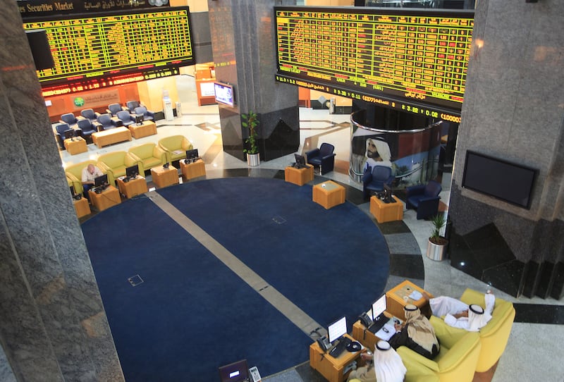 ABU DHABI - UNITED ARAB EMIRATES - 14JAN2013 - Share holders watch the display of share market at (ADX) Abu Dhabi Securities Exchange. Ravindranath K / The National 