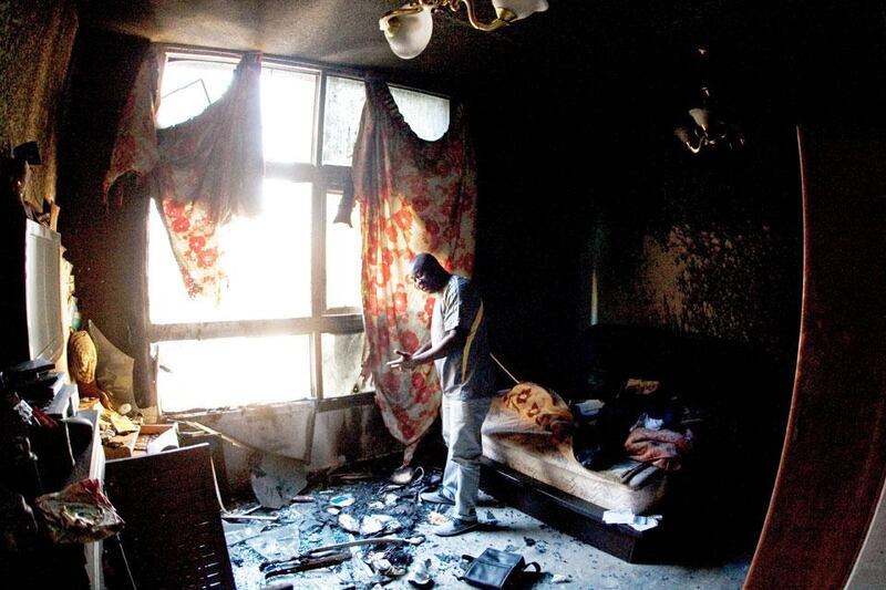 Standing in what was his bedroom Dove Ifeanyi estimates he lost 200,000 AED in cash and belongings when a fire gutted several apartment last week in the Al Baker Apartments in Sharjah City, Sharjah.  Jeff Topping / The National