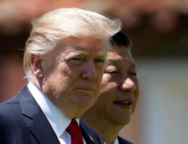 FILE - In this April 7, 2017, file photo, U.S. President Donald Trump, left, and Chinese President Xi Jinping walk together at Mar-a-Lago in Palm Beach, Fla. Despite Trump's hopes for China's help in dealing with North Korea and his recent tough talk on the matter, the two sides seem to be growing further apart as their approaches and concerns diverge. China shows no sign of caving in to U.S. pressure to tighten the screws on North Korea, while the North's recent missile tests have done little to rattle Beijing. China's bottom line continues to hold: no to any measures that might topple Kim Jong Un's hard-line communist regime. (AP Photo/AlexÂ Brandon, File)