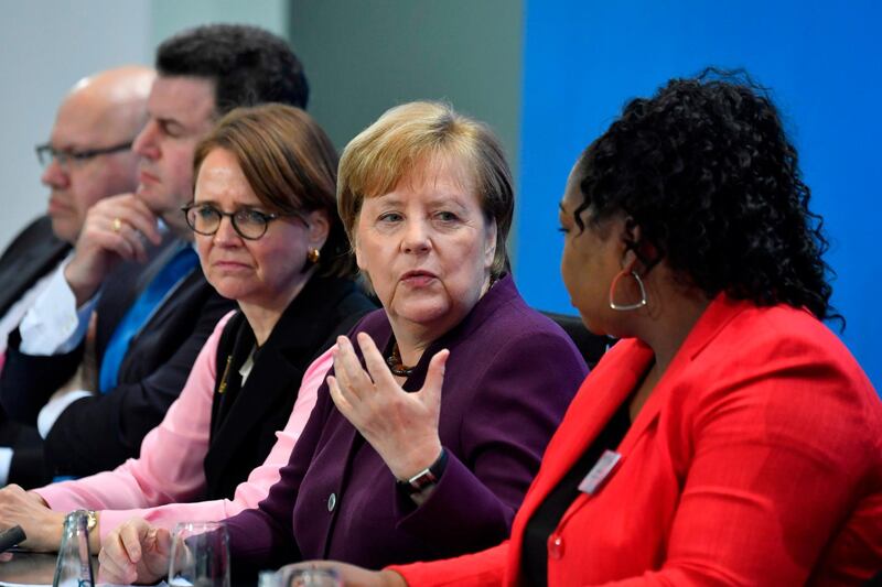 (L-R) German Economy Minister Peter Altmaier, German Labour Minister Hubertus Heil, German State Minister for Migration, Refugees and Integration Annette Widmann-Mauz, German Chancellor Angela Merkel and Sylvie Nantcha, head of The African Network of Germany (TANG), give a press conference at the end of a summit on integration at the Chancellery in Berlin on March 2, 2020.  German Chancellor Angela Merkel is hosting the summit, where politicians, scientists, representatives of the economy, the media, social associations and of the civil society meet to discuss issues of the  country's integration policy. / AFP / John MACDOUGALL

