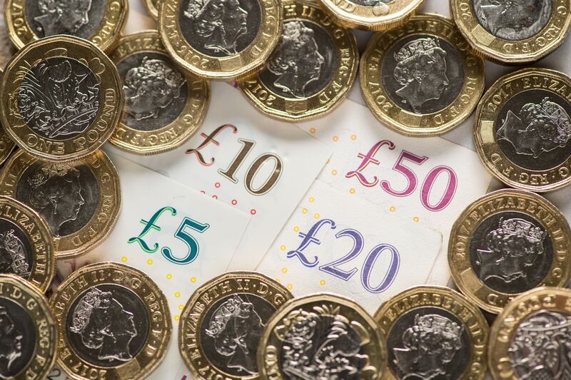 UK banknotes and coins. British Chancellor Jeremy Hunt welcomed the reduction in inflation but said 'the fight is far from over'. PA