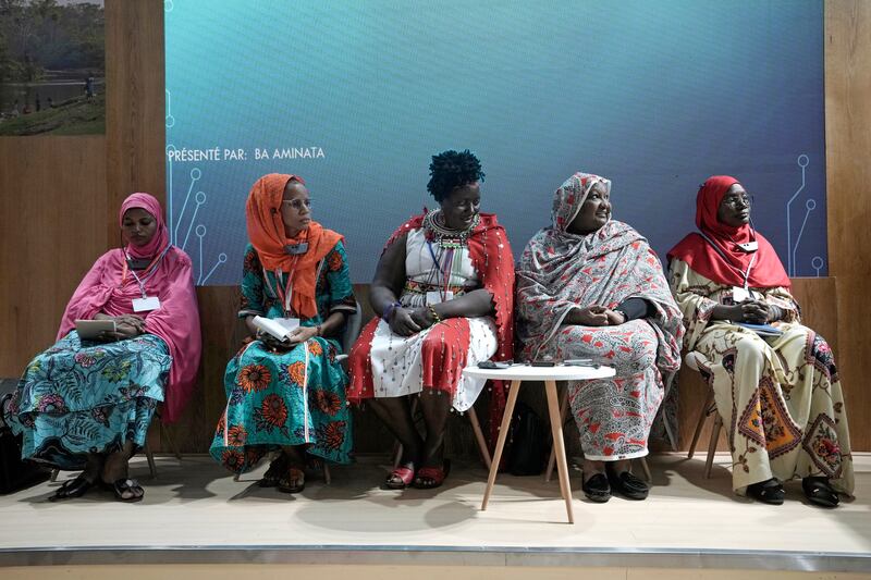 From left, Rakia Amandou of Niger, Ba Aminata of Burkina Faso, Kenyan Rosemary Nenini, Fatima Mustafa Ahmed from Sudan and Djeneb Dicko from Burkina Faso at the Indigenous Peoples Pavilion. AP