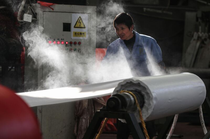 This photo taken on January 1, 2020 shows an employee working at a textile factory in Hangzhou in China's eastern Zhejiang province. China OUT
 / AFP / STR
