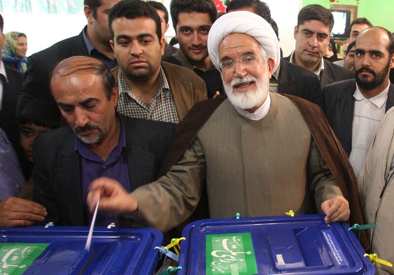 (FILES) This file photo taken on June 12, 2009 shows Iranian presidential candidate Mehdi Karroubi casting his ballot at a polling station in Tehran. 
Iranian opposition leader Mehdi Karroubi, under house arrest for the past six years, was hospitalised on August 17, 2017 after going on hunger strike to demand a trial, his family told local media. / AFP PHOTO / AFP FILES / ATTA KENARE