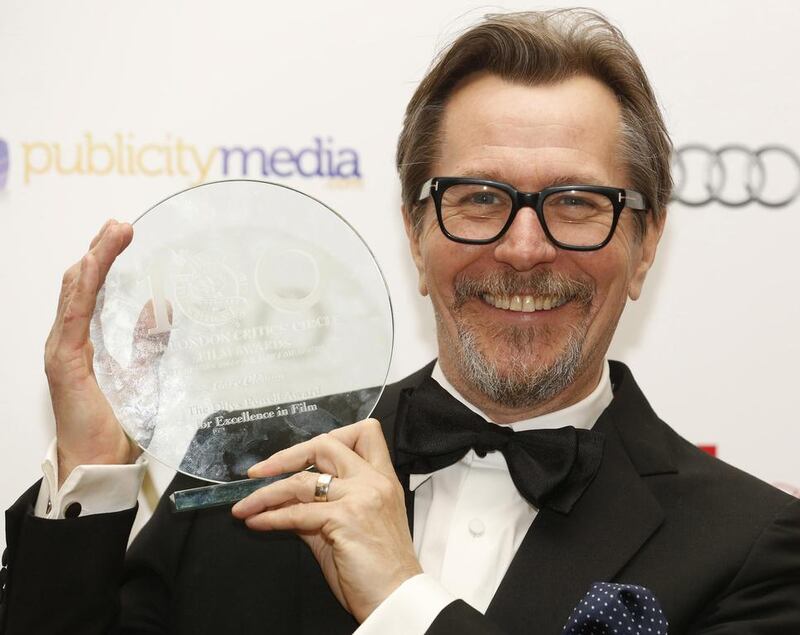 Actor Gary Oldman poses with his award the "Dilys Powell Award for Excellence in Film" award at the London Critics' Circle Film Awards in London on February 2, 2014.  Luke MacGregor / Reuters